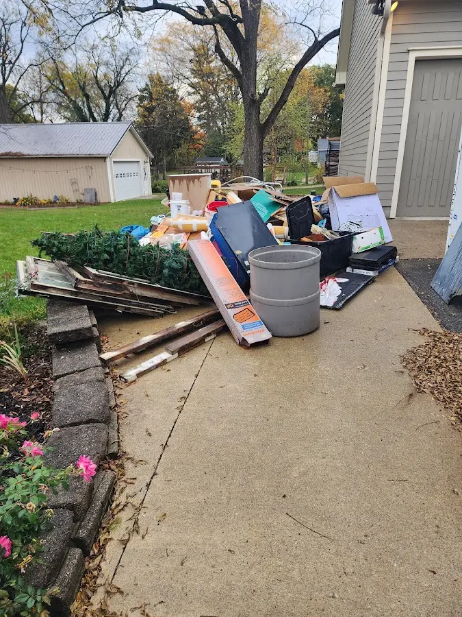 Dumpster being loaded with debris for Residential Dumpster Rental in North Shore